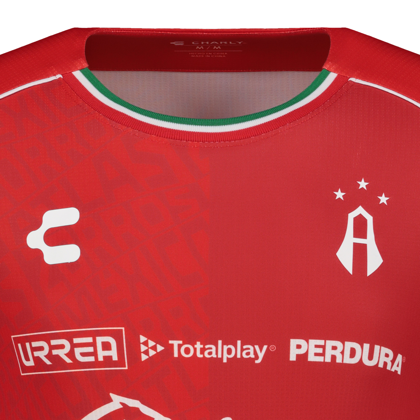 Close-up of a red Atlas FC soccer jersey by Charly, featuring sponsor logos and a Mexican flag-colored collar trim.