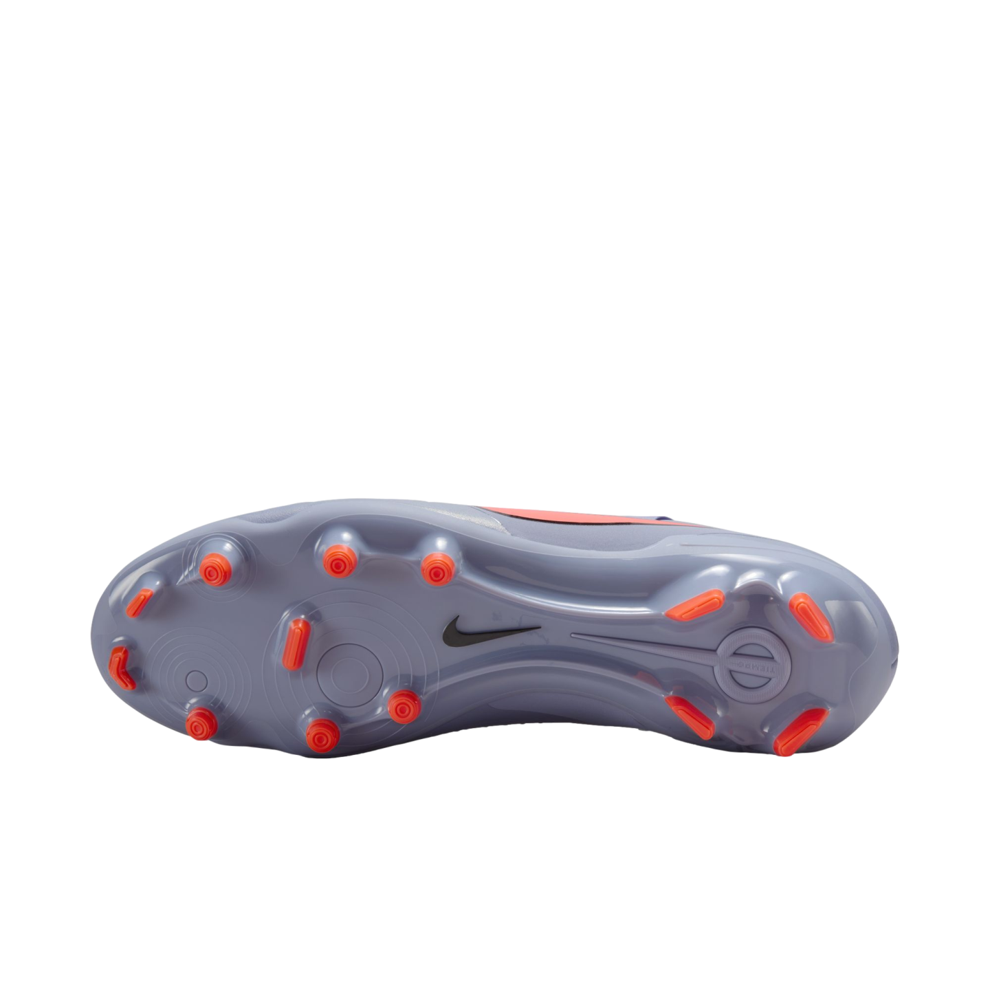 The lavender soleplate of a Nike soccer cleat featuring bright orange studs and a small black swoosh, isolated against a black background.