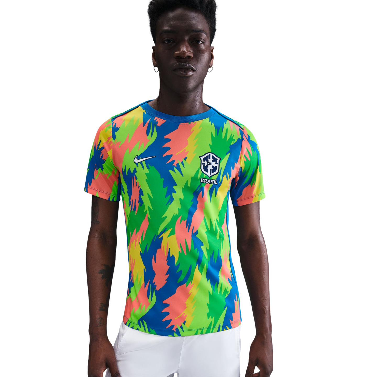 A man in a colorful Nike Brazil soccer jersey with a vibrant jagged pattern and the CBF crest, set against a plain white background.