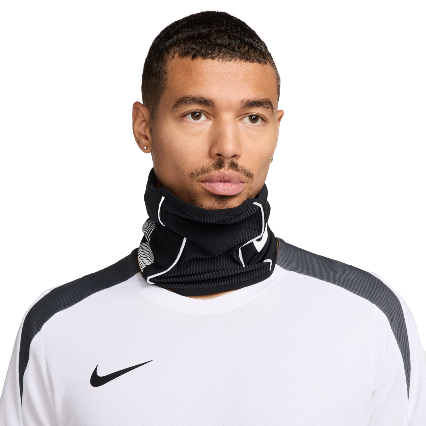 Close-up of a man wearing a black Nike neck gaiter and a white Nike athletic shirt against a black background.