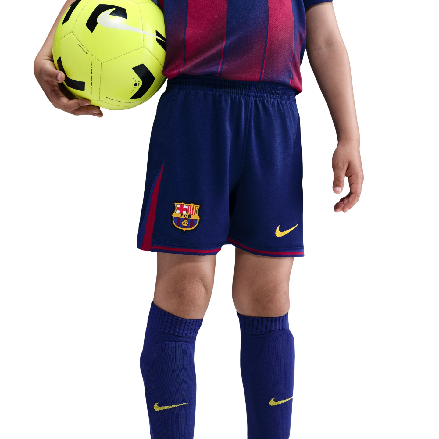 A child wearing an FC Barcelona soccer uniform holds a neon yellow soccer ball against a black background.