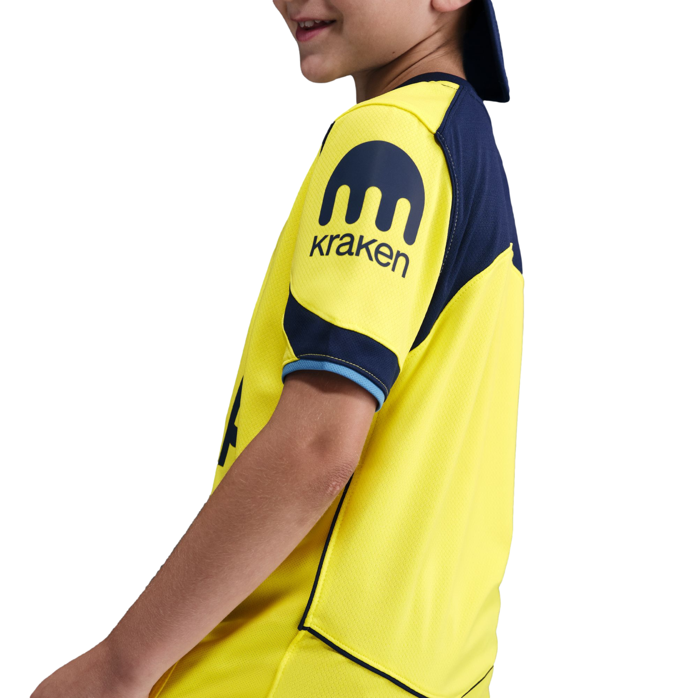 A profile view of a child wearing a yellow and navy blue sports jersey with a Kraken logo on the sleeve, against a black background.