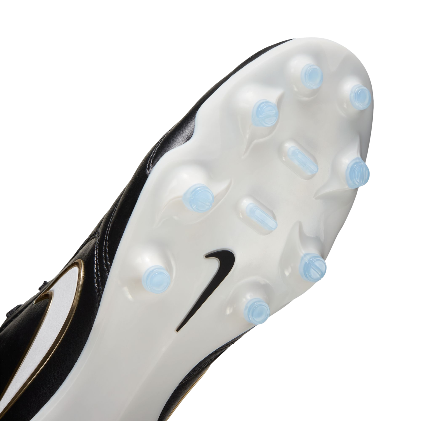 Bottom view of a Nike soccer cleat featuring a white soleplate with light blue studs and a black swoosh logo.