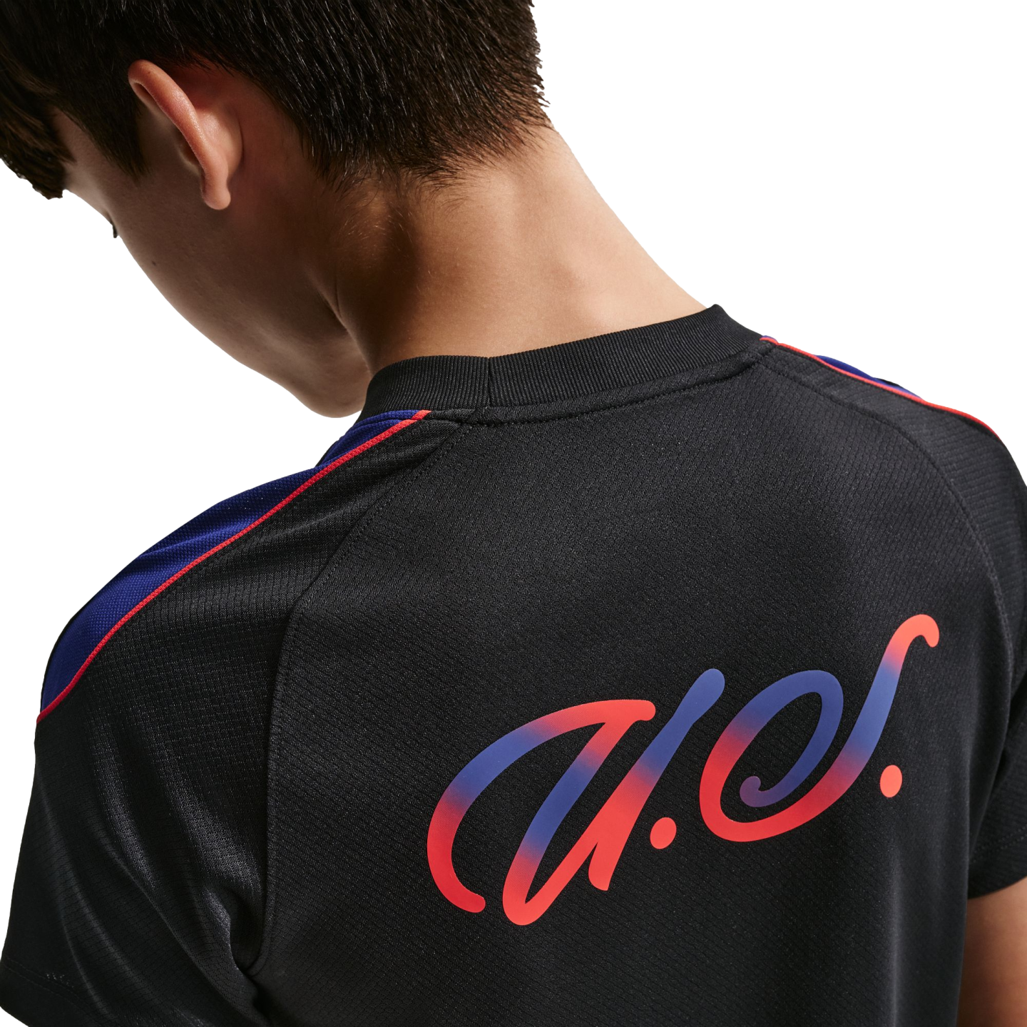 Close-up rear view of a person in a black jersey featuring a stylized red and blue gradient logo and shoulder stripes.
