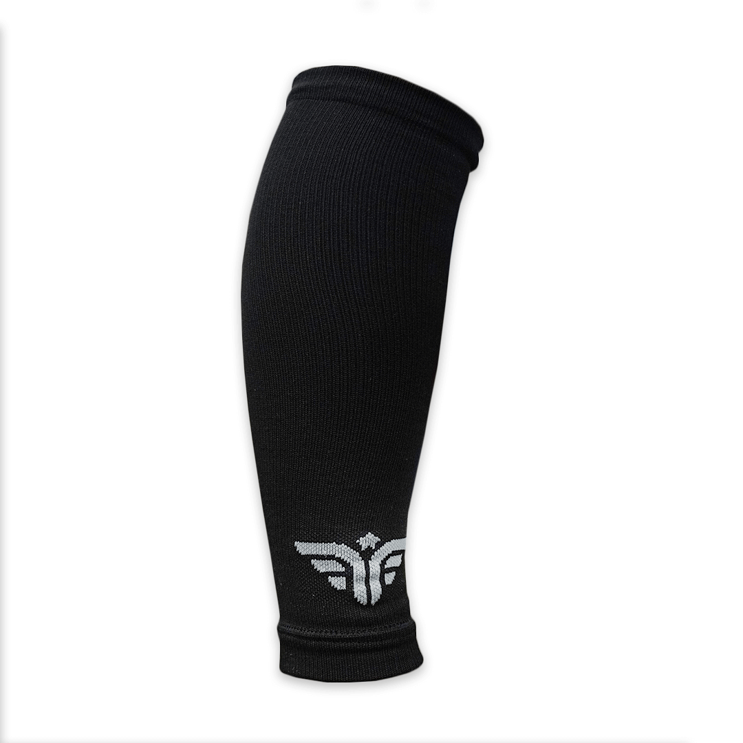 A single black For The Footballer XLR8R Regular Leg Sleeve featuring a grey embroidered winged logo at the bottom, shown against a plain white background.