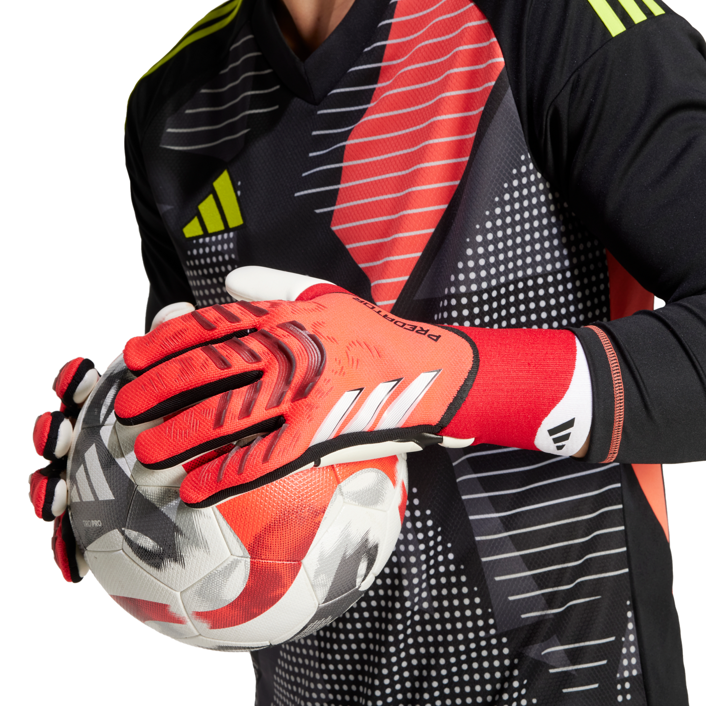 Goalkeeper in a patterned jersey and red Adidas gloves holding a soccer ball.