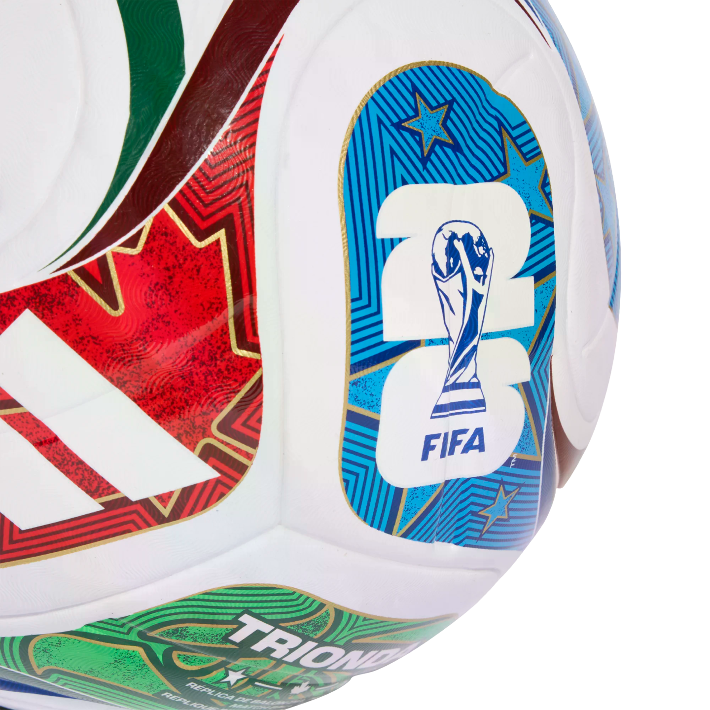Close-up of a white Adidas soccer ball featuring the FIFA World Cup 2026 logo, red and green patterned stripes, and "TRIONFO" text.