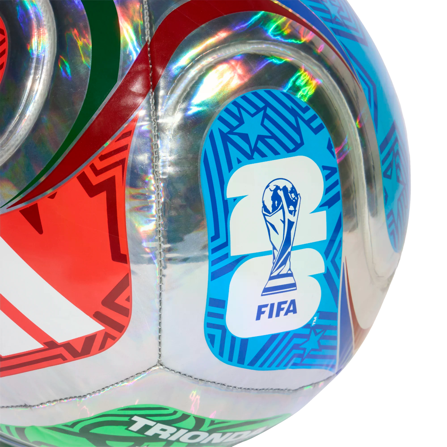 Close-up of a holographic silver soccer ball featuring colorful red, green, and blue geometric patterns and the FIFA World Cup 2026 logo.