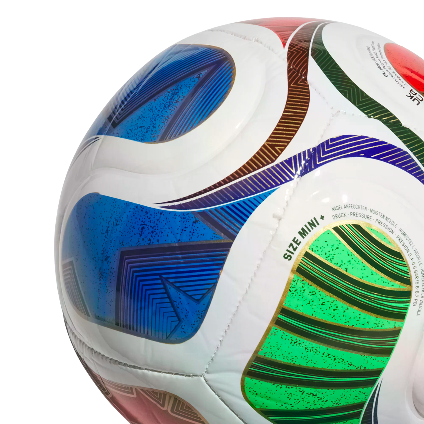 Close-up of a white mini soccer ball with vibrant blue, green, and red geometric patterns and gold accents. Text "SIZE MINI +" is visible. Isolated against a black background.