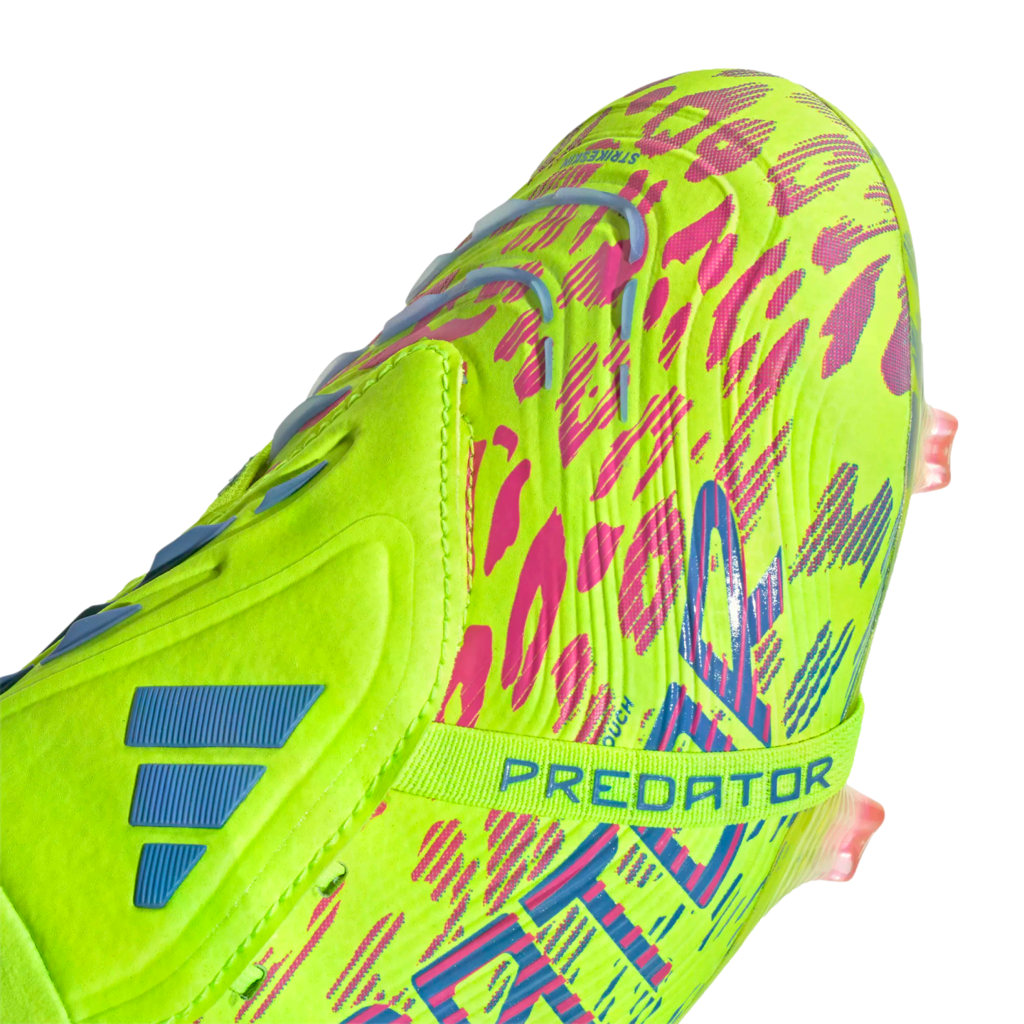 Close-up of a lime green Adidas Predator soccer cleat featuring vibrant pink and blue patterns and a midfoot strap.