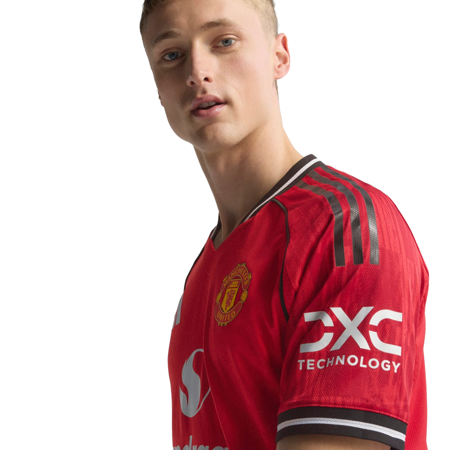A blonde man wearing a red Manchester United football jersey with the club crest and sponsor logos against a black background.