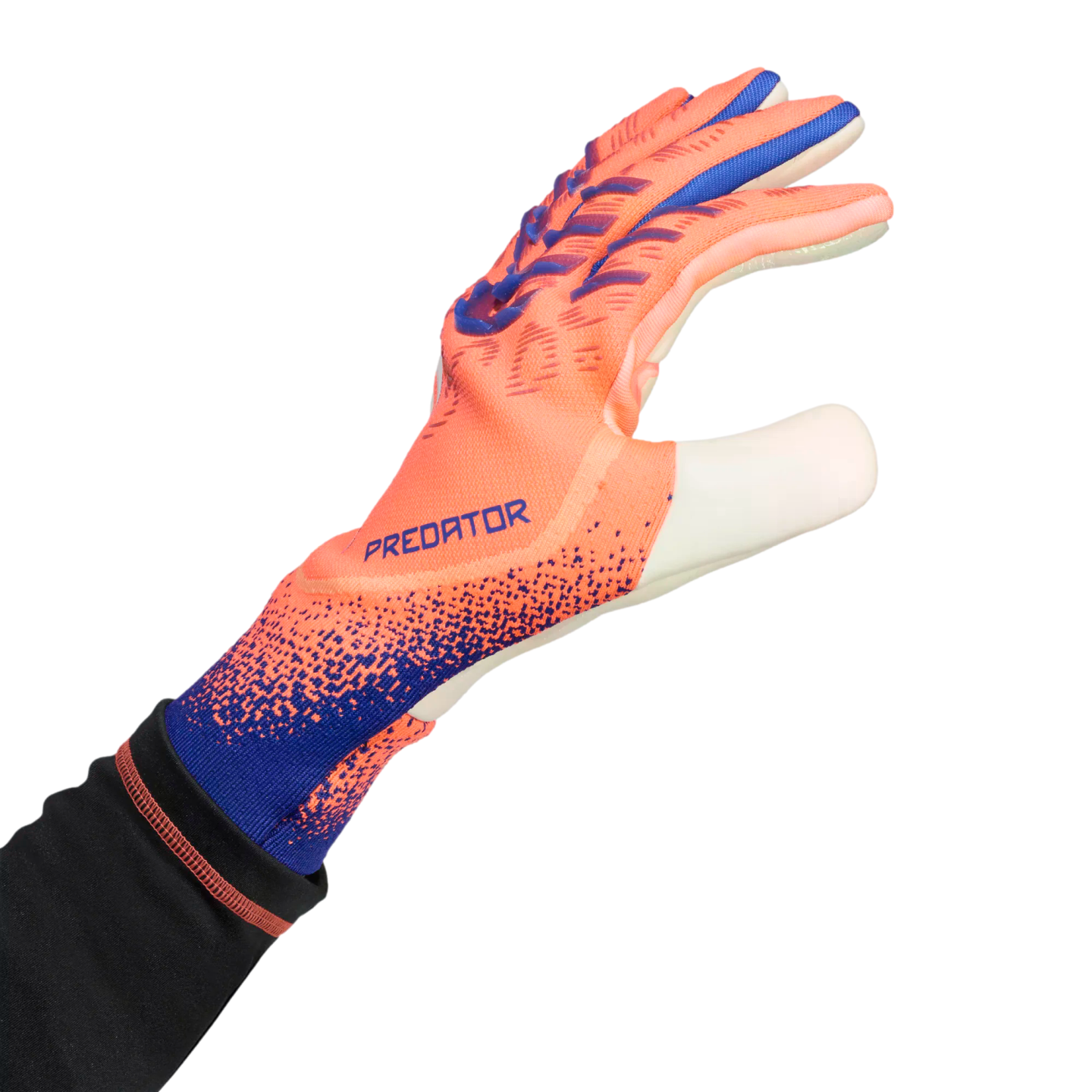 An orange and blue Adidas Predator goalkeeper glove worn on a hand, reaching out against a black background.