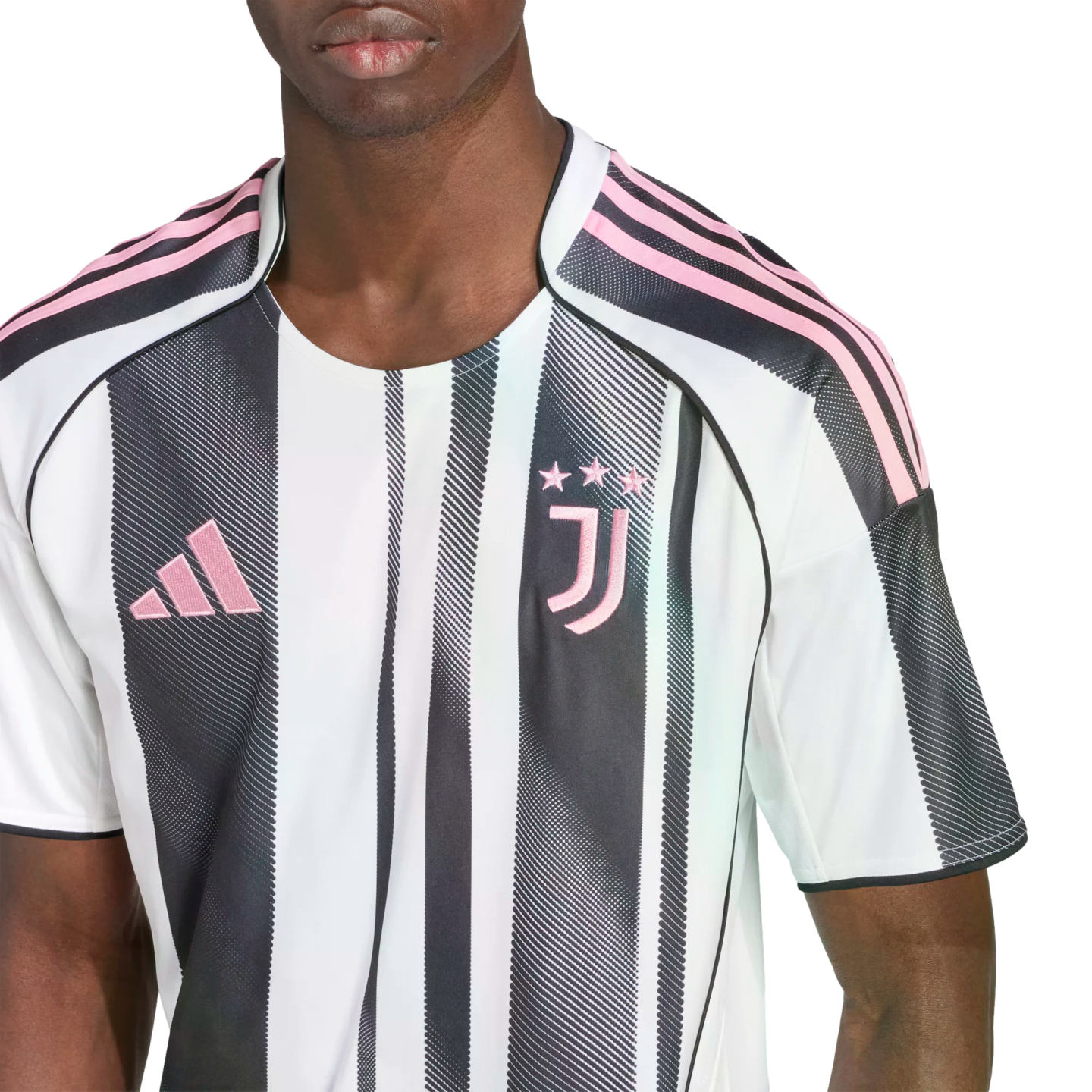 Close-up of a person wearing a white and black striped Juventus soccer jersey with pink logos.