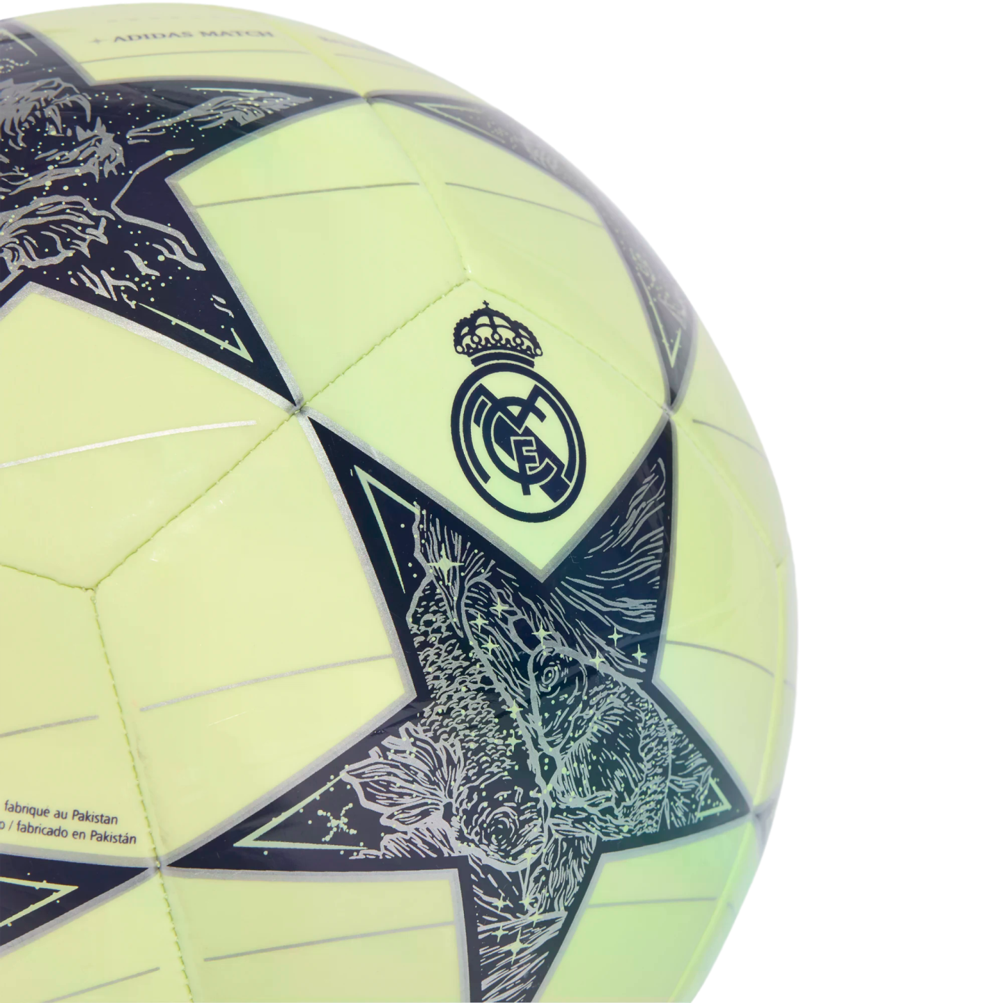 Close-up of a lime green soccer ball featuring the Real Madrid crest and Champions League star pattern with intricate graphics.