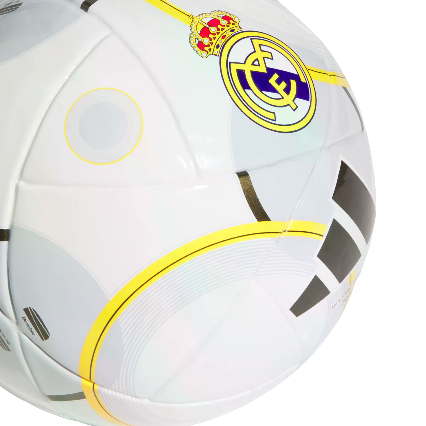 A white soccer ball featuring the Real Madrid club crest, the Adidas logo, and yellow and grey circular graphic patterns.