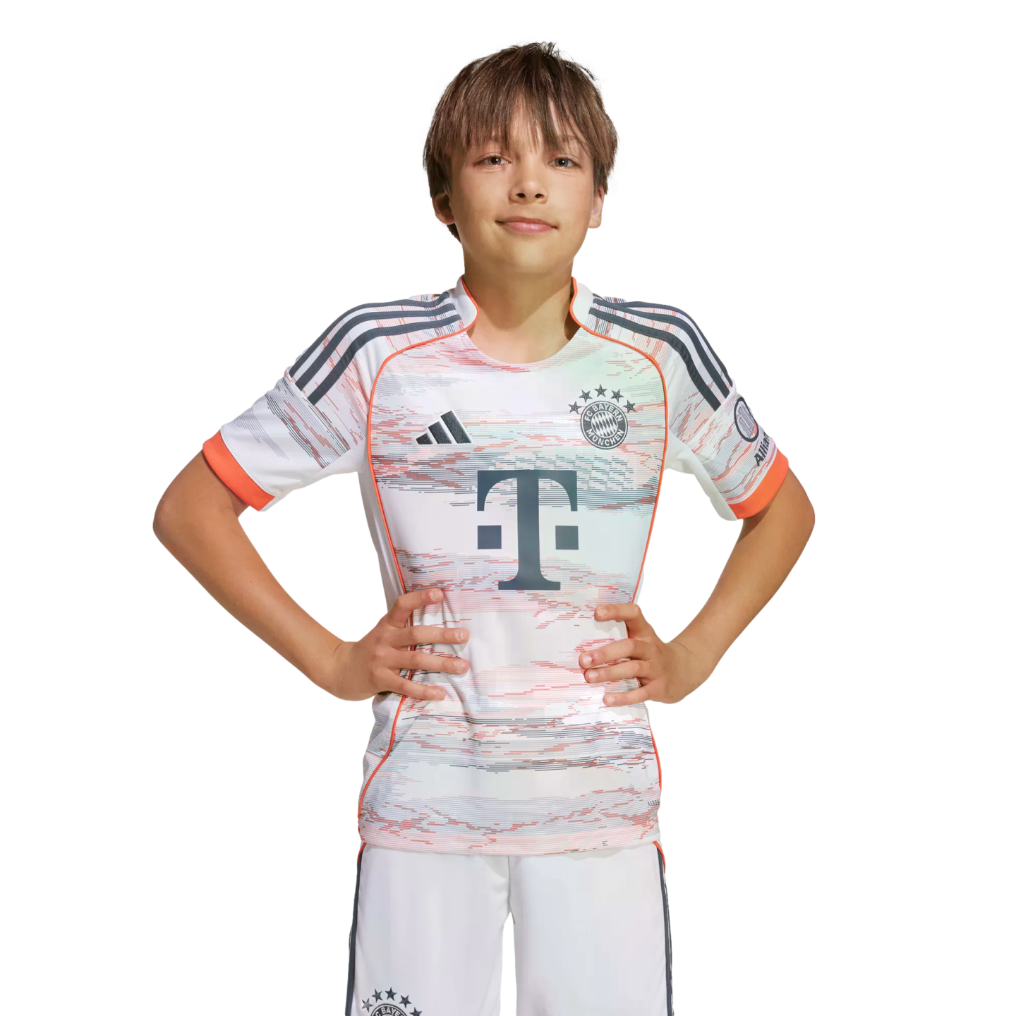 A young boy wearing an Adidas FC Bayern Munich away football kit stands with hands on hips against a white background.