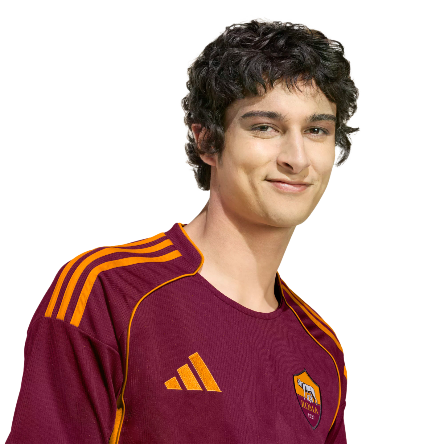 A young man with dark curly hair wearing a maroon and orange AS Roma soccer jersey, smiling against a black background.