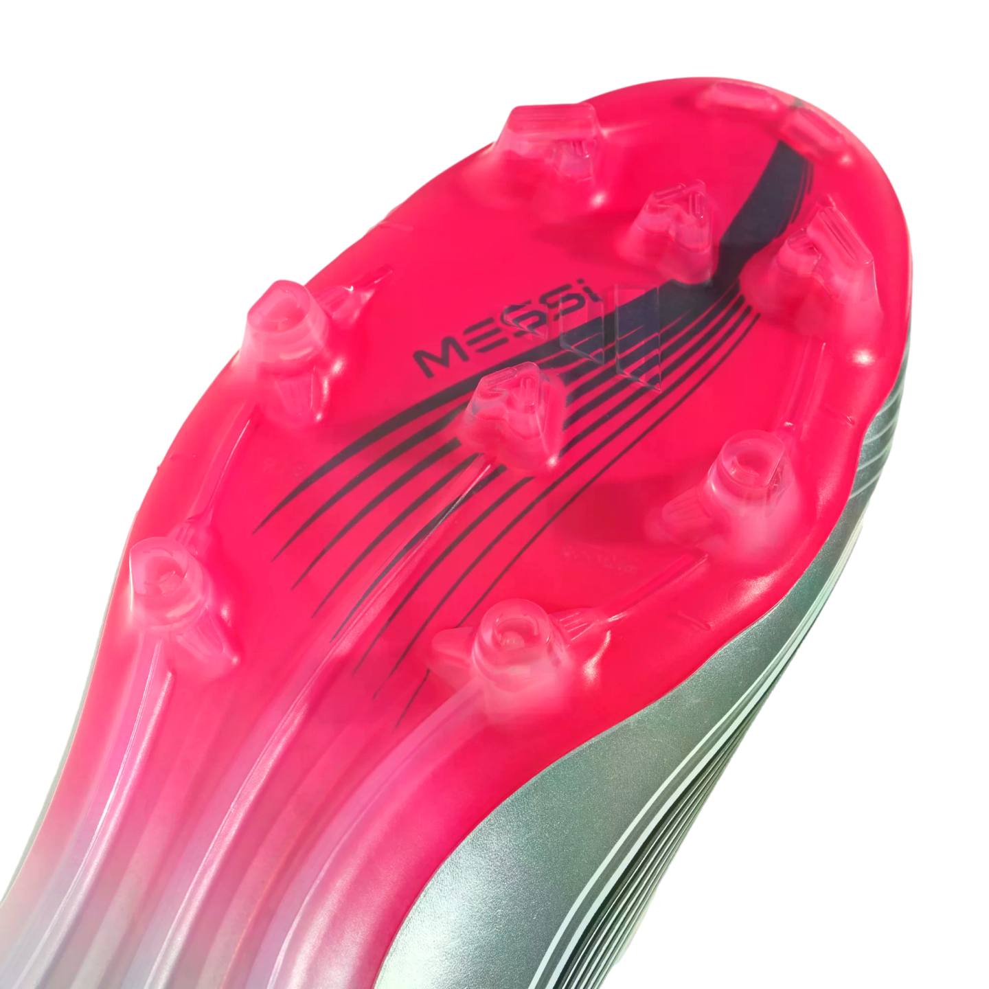 Close-up of a vibrant pink and silver soccer cleat sole with clear studs and "MESSI" branding.