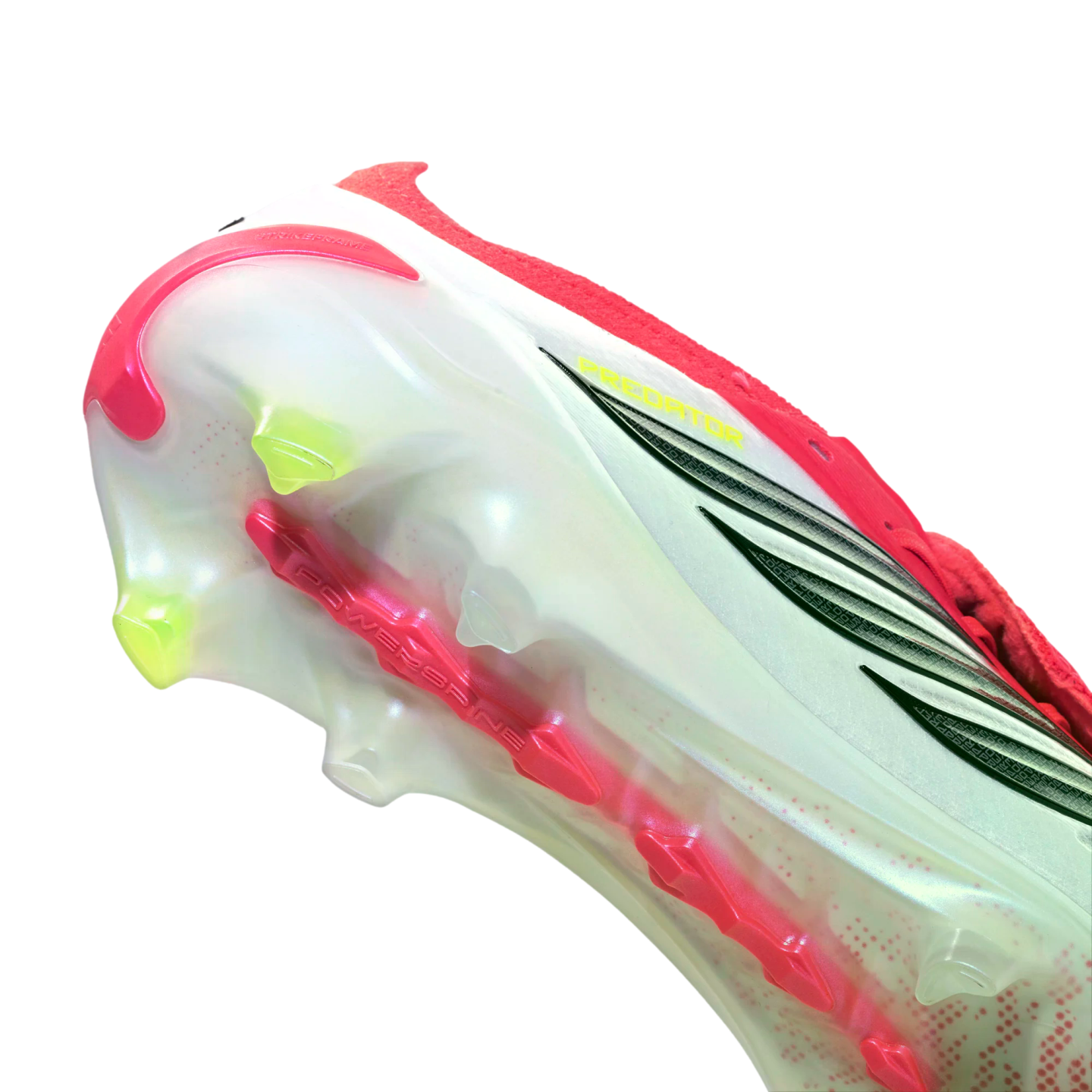 Close-up of an Adidas Predator soccer cleat's translucent white soleplate featuring lime green studs and a red central power spine.
