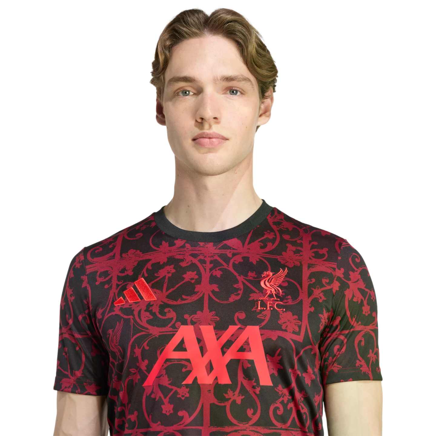Young man in a black Liverpool FC training shirt with a red floral pattern, featuring the Adidas logo, L.F.C. crest, and AXA sponsor, set against a black background.