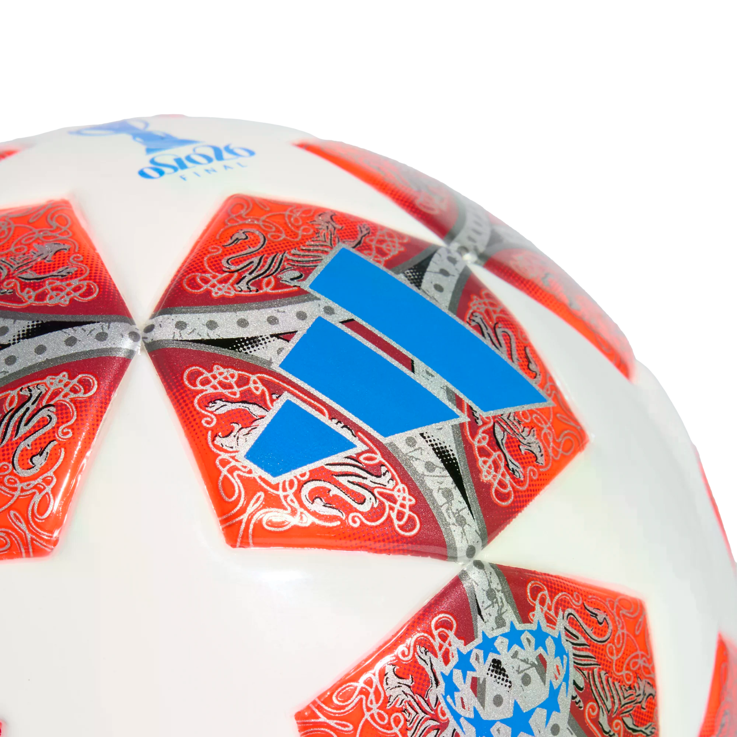 A close-up of a white Adidas soccer ball with orange star-shaped panels featuring intricate silver patterns and a prominent blue logo.