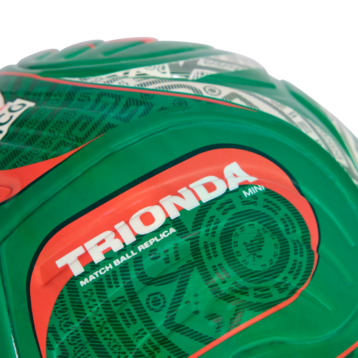 Close-up of a green soccer ball featuring the text "TRIONDA" in bold white letters on a red background, with "MATCH BALL REPLICA" and "MINI" printed below.