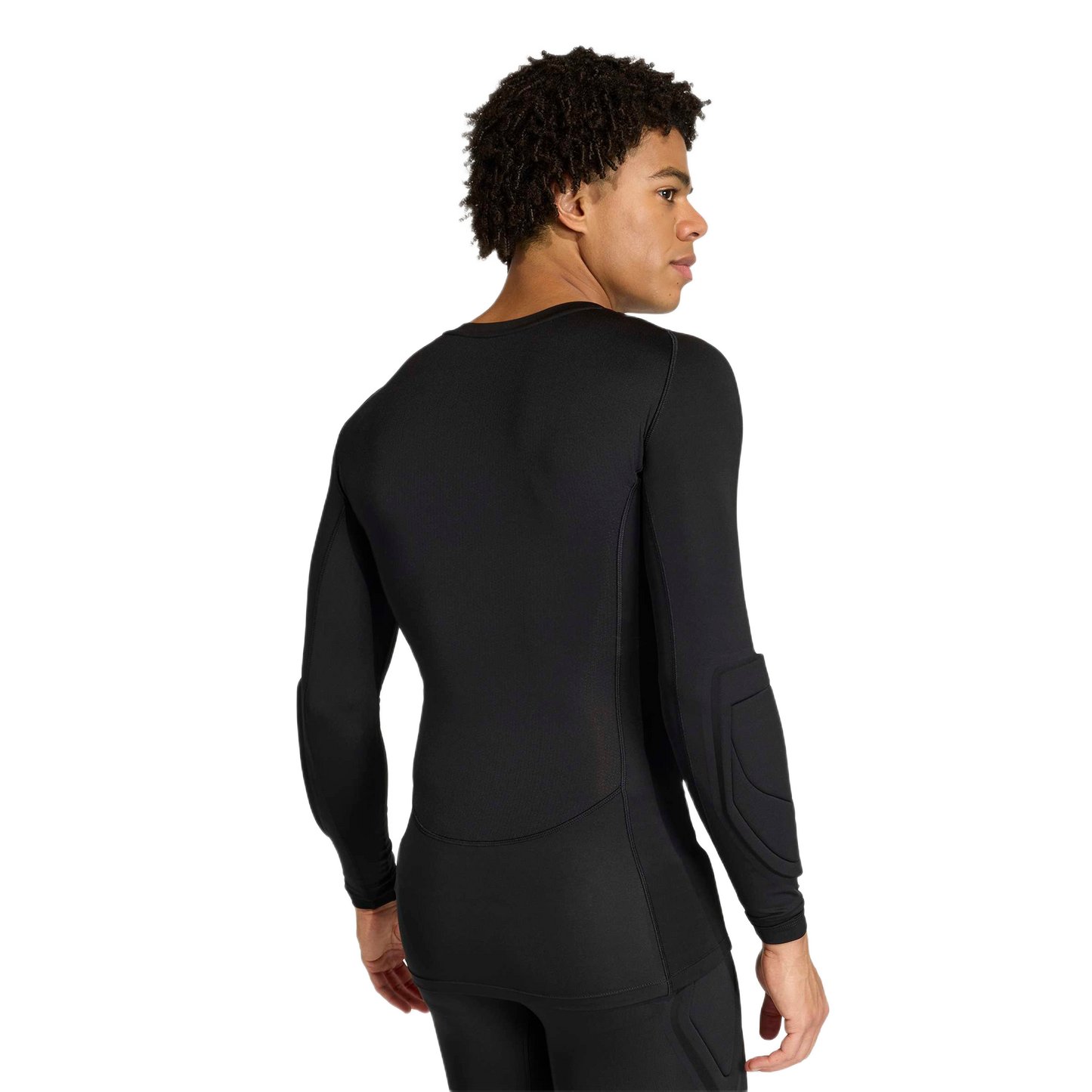 Rear view of a man wearing a black long-sleeved athletic compression shirt with elbow padding and matching black leggings.