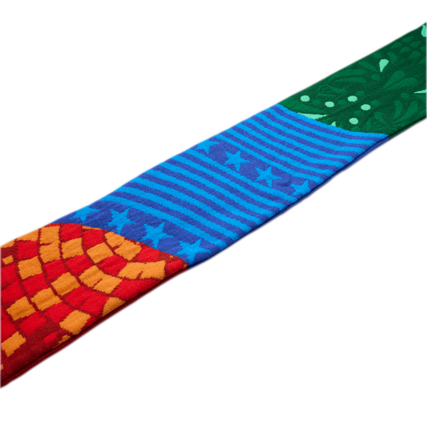 A colorful patterned fabric strip featuring a red and orange mosaic, blue stars and stripes, and a green floral design, set against a white background.