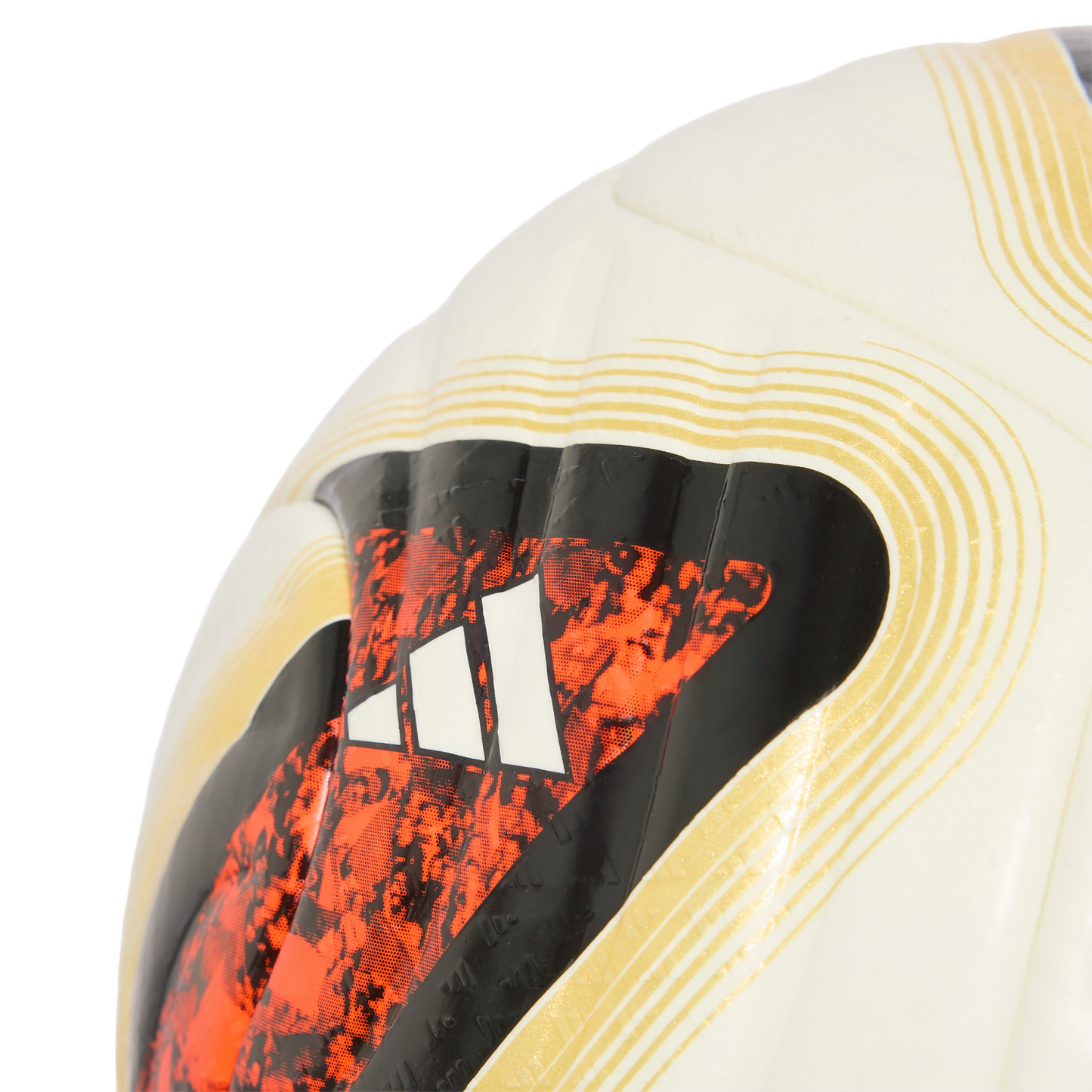 Close-up of a white Adidas soccer ball featuring a black and orange textured graphic and the iconic three-bar logo.