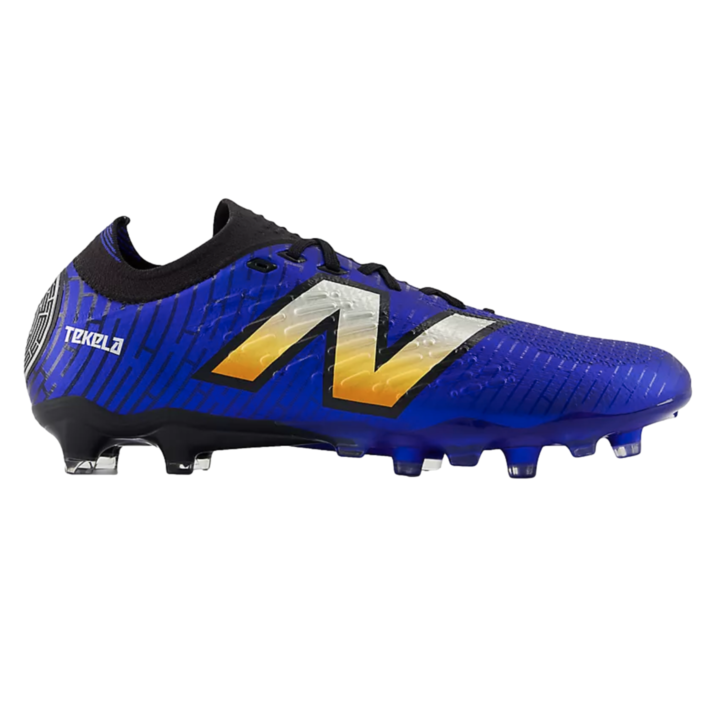 Side view of a blue New Balance Tekela soccer cleat with a silver and gold gradient logo, black accents, and clear studs on a plain white background.