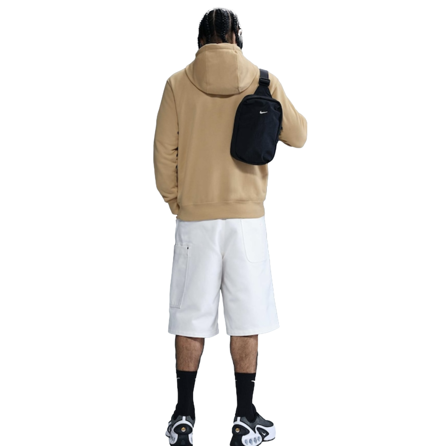 Rear view of a person wearing a tan hoodie, white shorts, black socks, and sneakers with a black cross-body bag over their shoulder.