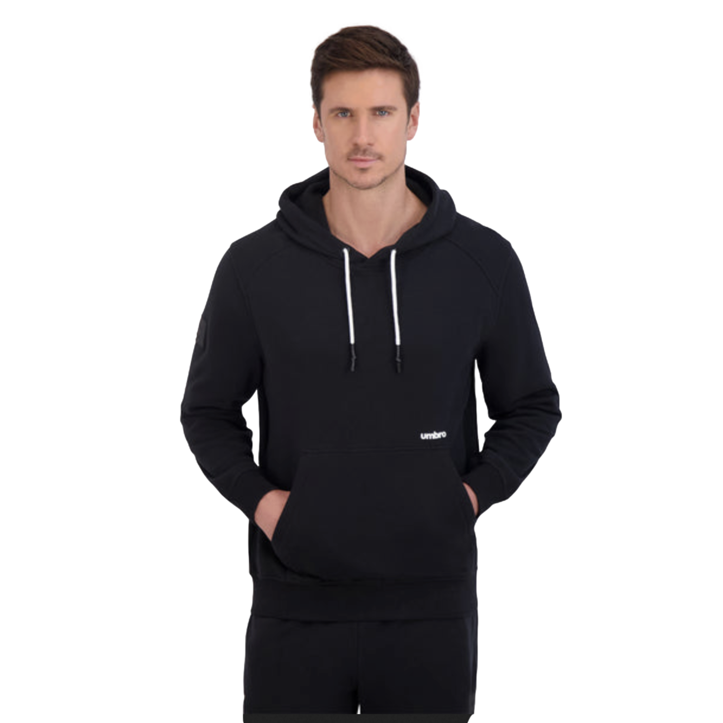 A man wearing a black Umbro hoodie with white drawstrings and hands in the front pocket, set against a solid black background.