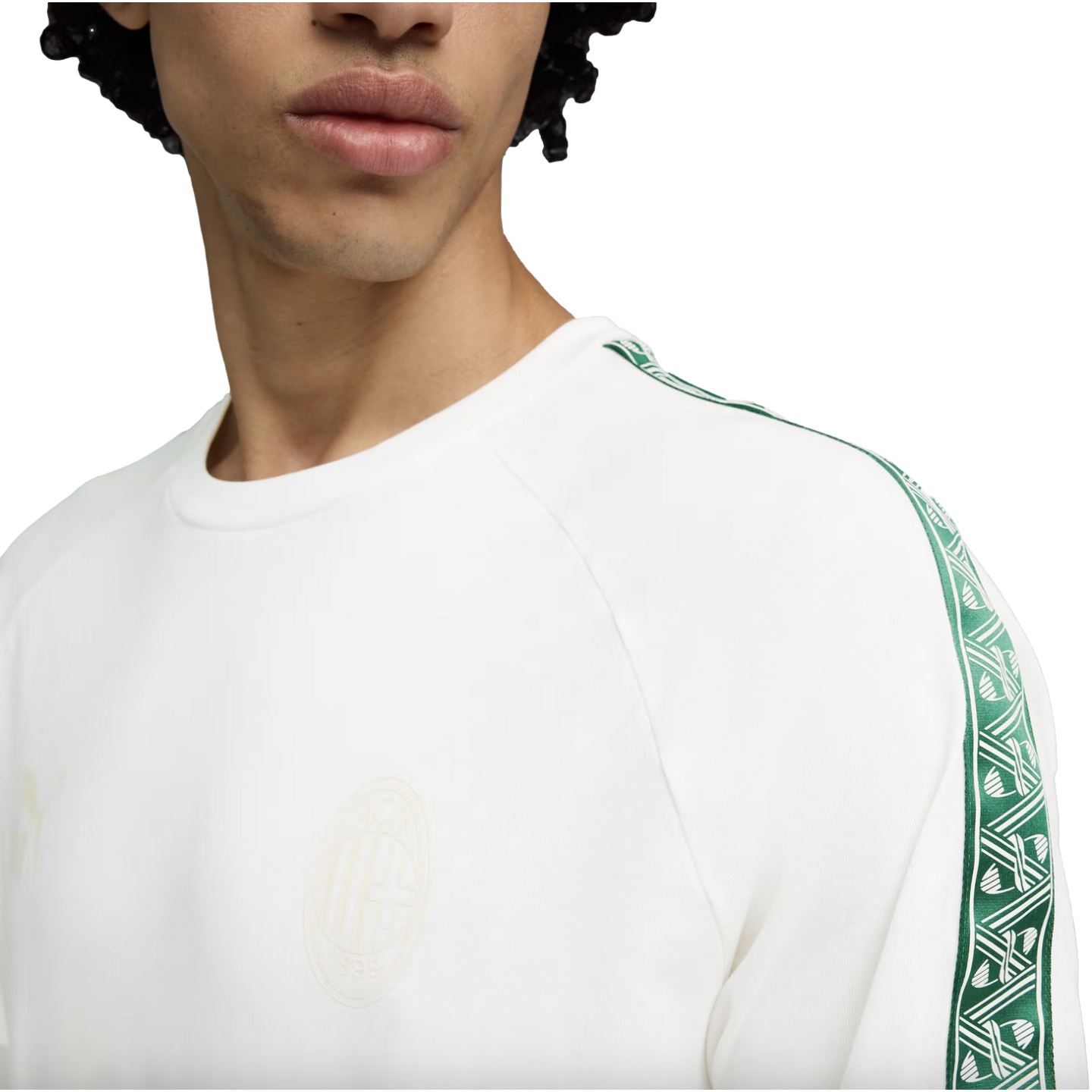 Person wearing a white AC Milan sweatshirt with green patterned sleeve trim and a faint chest crest.
