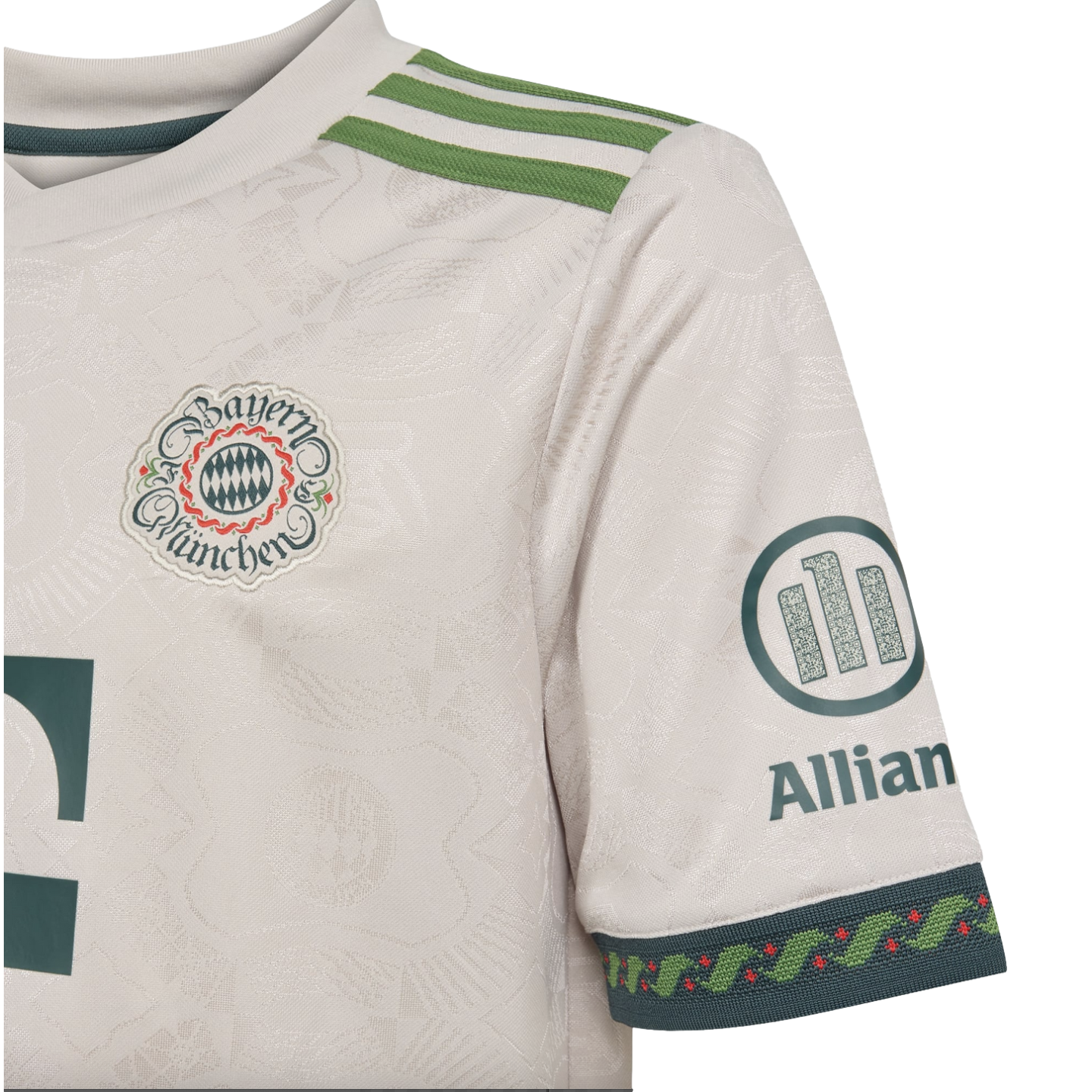 Close-up of a white FC Bayern Munich soccer jersey featuring an intricate woven pattern, vintage-style crest, green shoulder stripes, and Allianz sleeve logo.