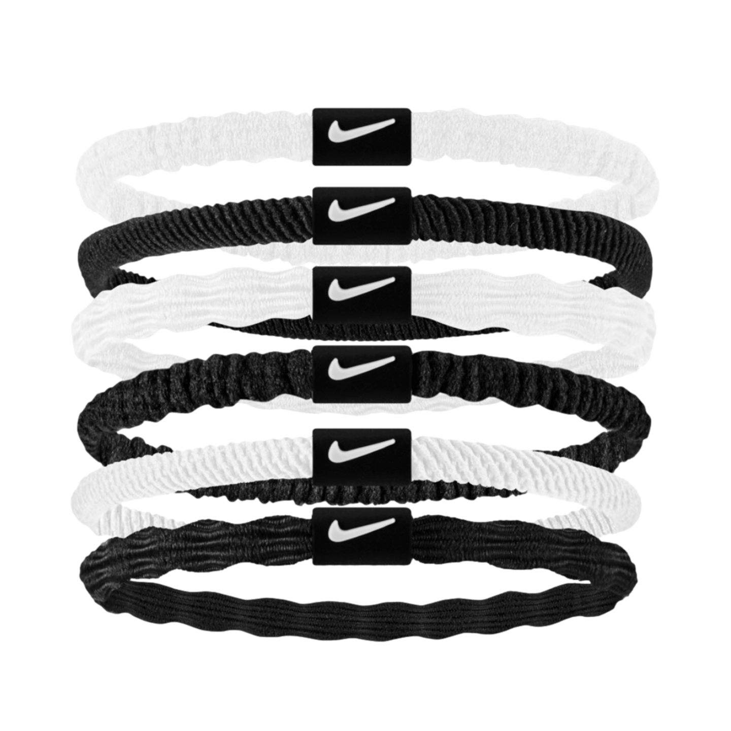 Six stacked Nike hair elastics in alternating white and black. Each band features a central black plastic tab with a white swoosh logo.