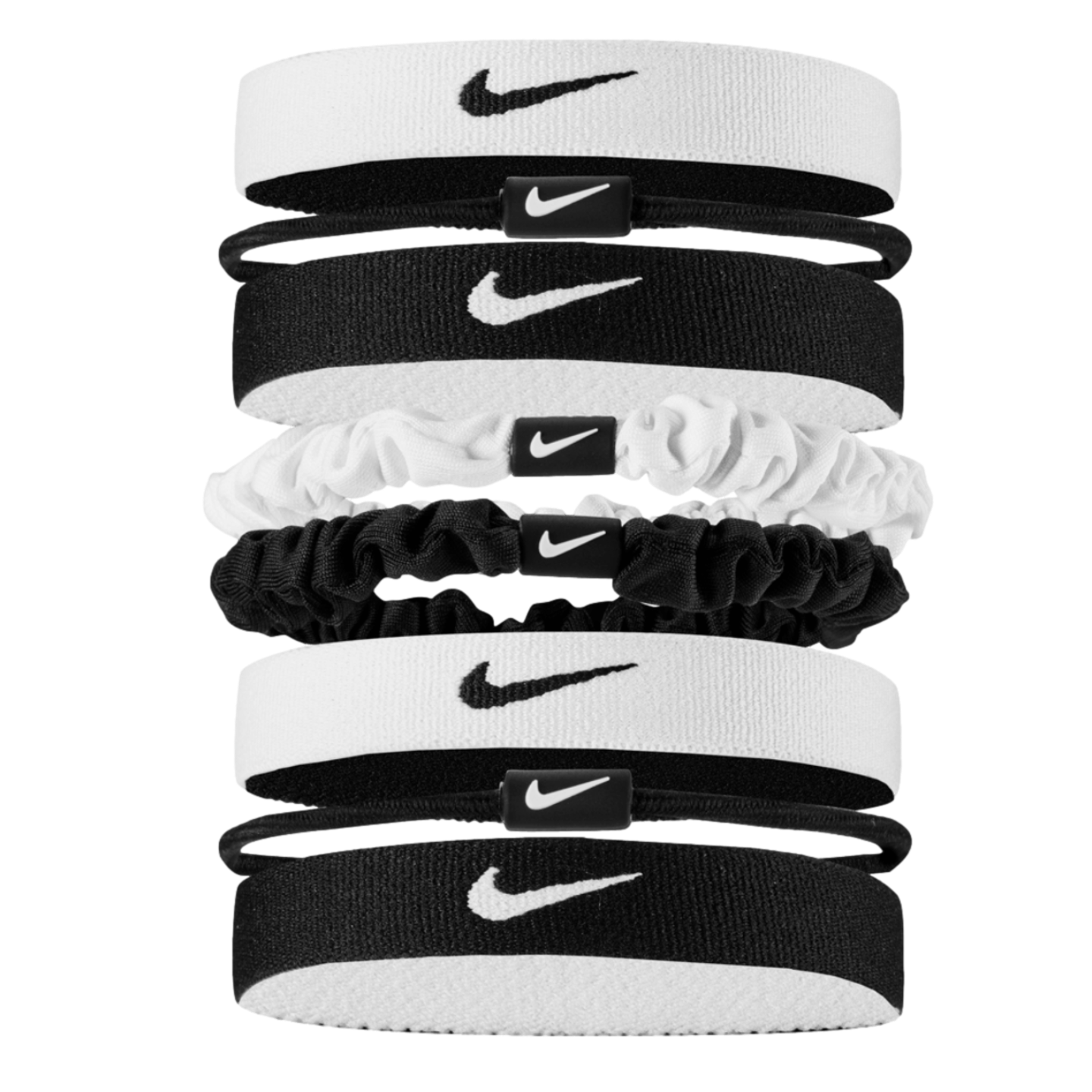 A vertical stack of eight black and white Nike hair accessories, including elastic headbands, thin hair ties, and scrunchies, all featuring the iconic swoosh logo against a black background.