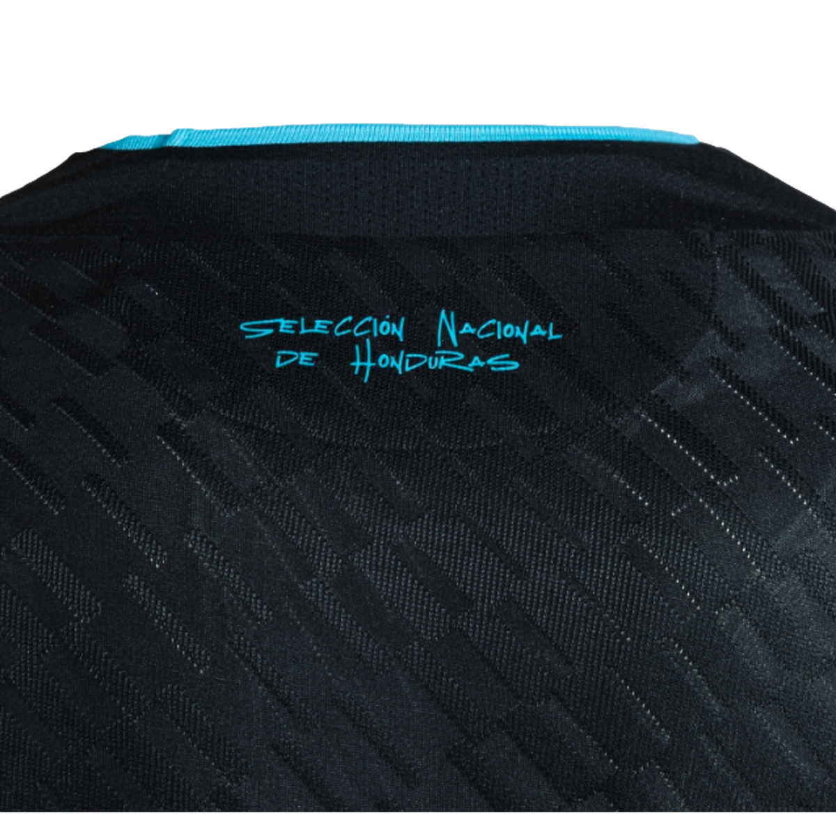 A close-up of the upper back of a black textured jersey, featuring a turquoise trim at the collar and the words "SELECCIÓN NACIONAL DE HONDURAS" printed in stylized turquoise text.
