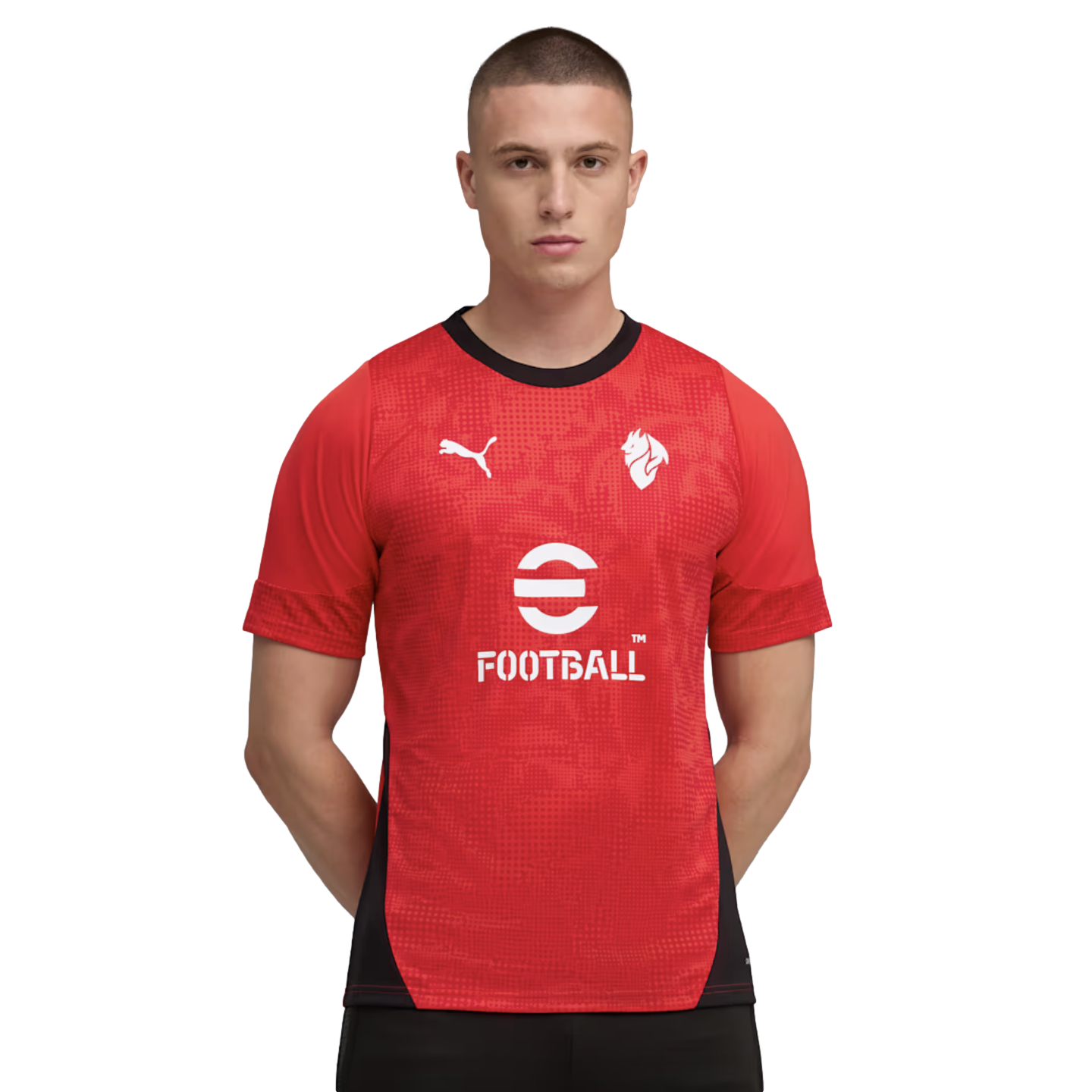 Man in a red Puma soccer jersey with white eFootball and Puma logos, featuring a black collar and side panels, against a black background.