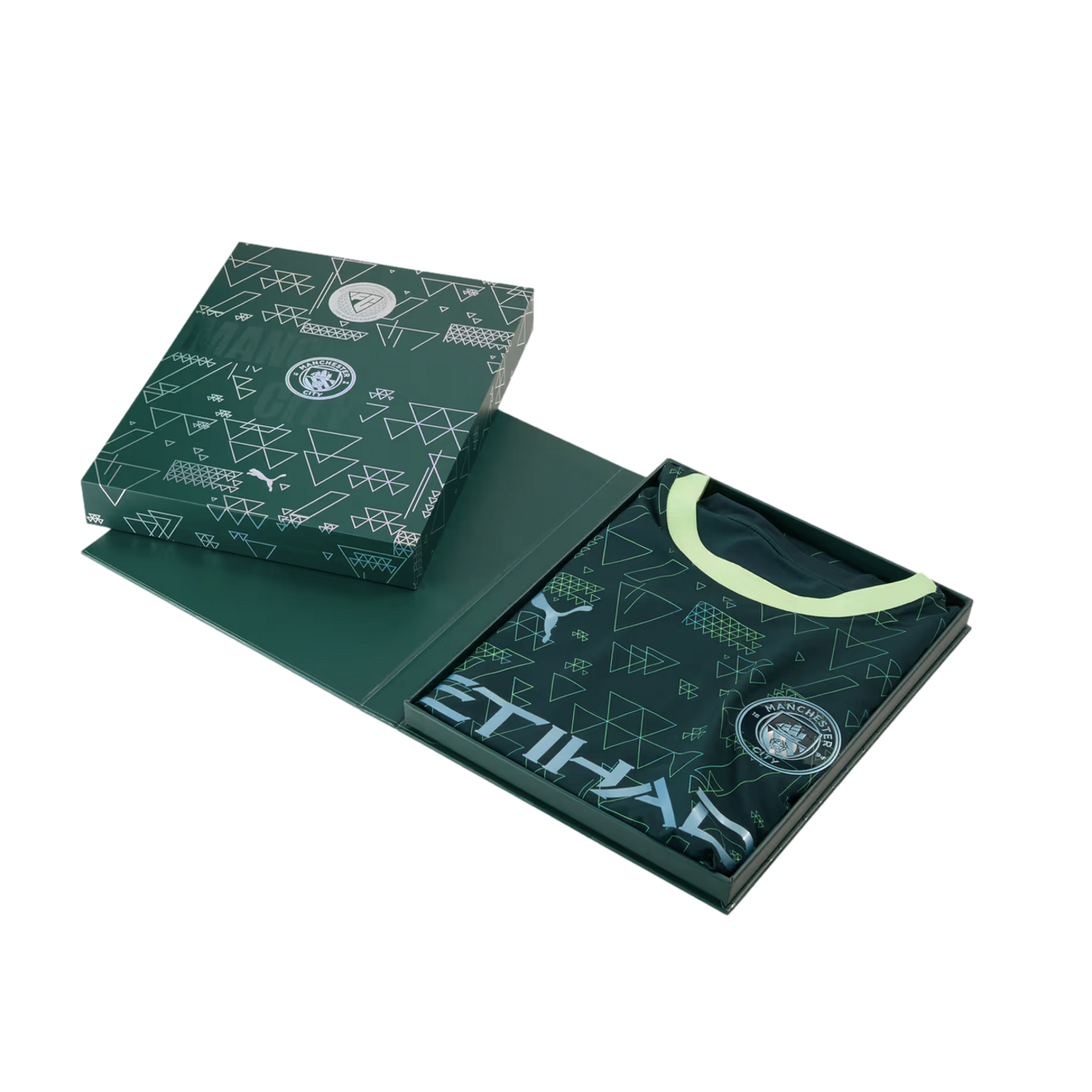 A dark green Manchester City football jersey with a geometric pattern and lime green collar, presented in its matching collector's box against a black background.