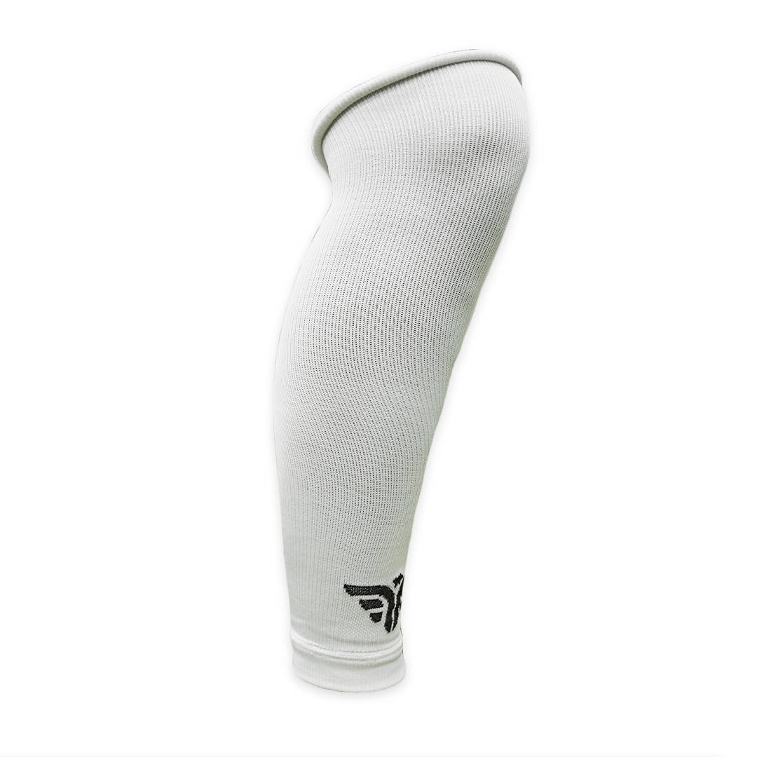 A white For The Footballer XLR8R Long Leg Sleeve featuring a ribbed texture and a small black logo near the bottom.
