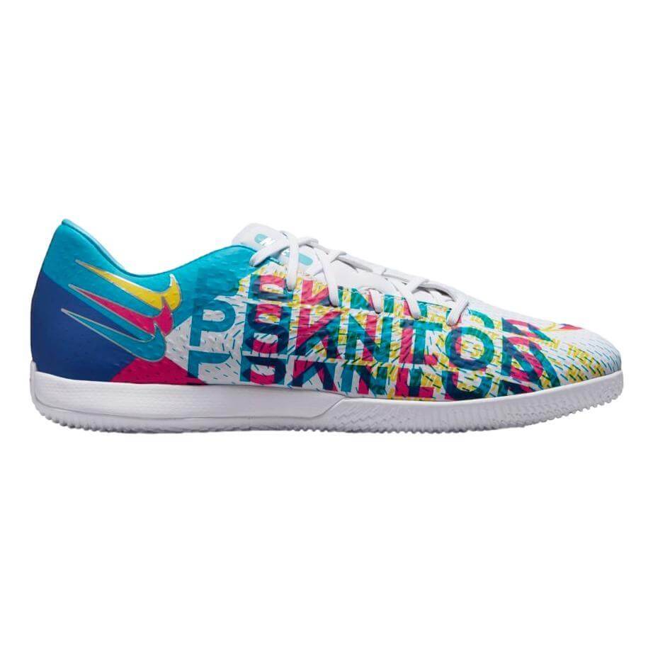 White Nike Phantom indoor soccer shoe with vibrant multicolored text graphics and a flat white rubber sole.