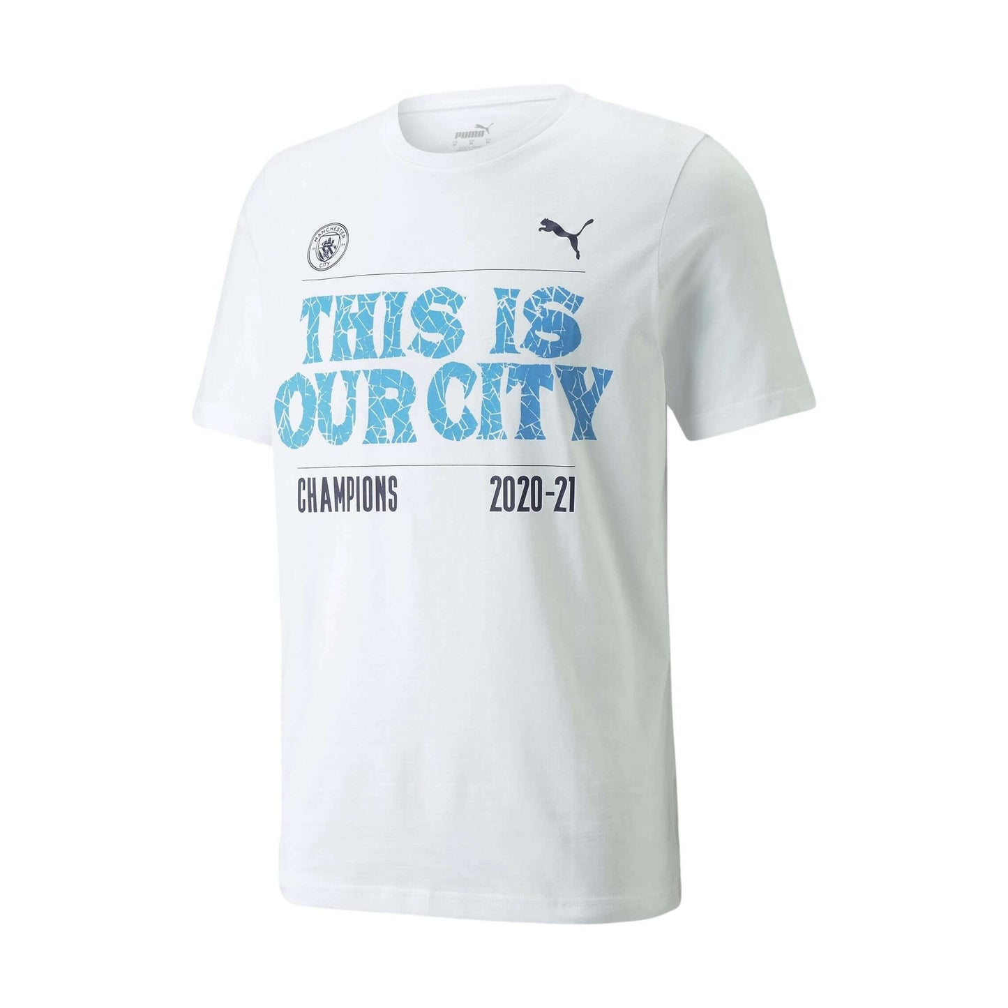 A white Puma t-shirt celebrating Manchester City's 2020-21 championship with "THIS IS OUR CITY" in blue text and "CHAMPIONS 2020-21" below. Includes club crest and Puma logo.