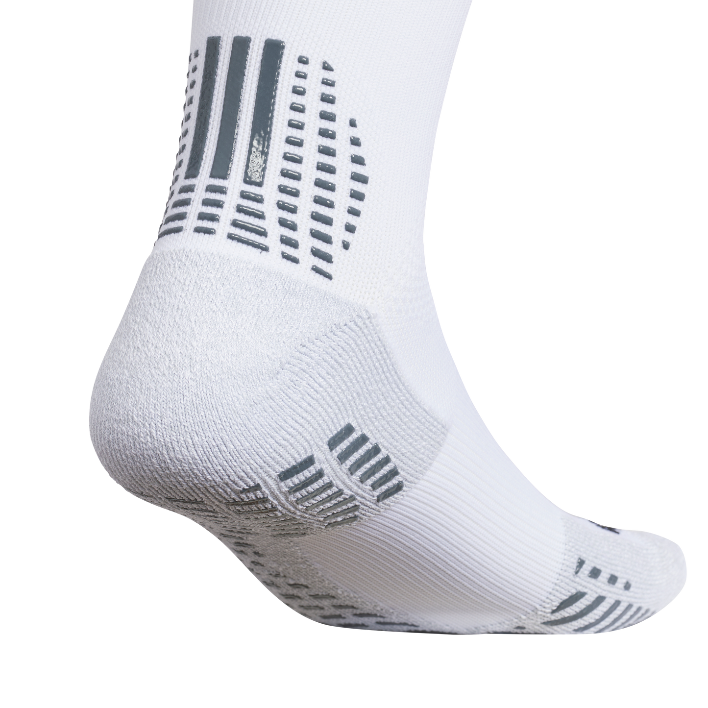 Close-up of a white performance sock with grey rubberized grip patterns on the heel and sole for traction.