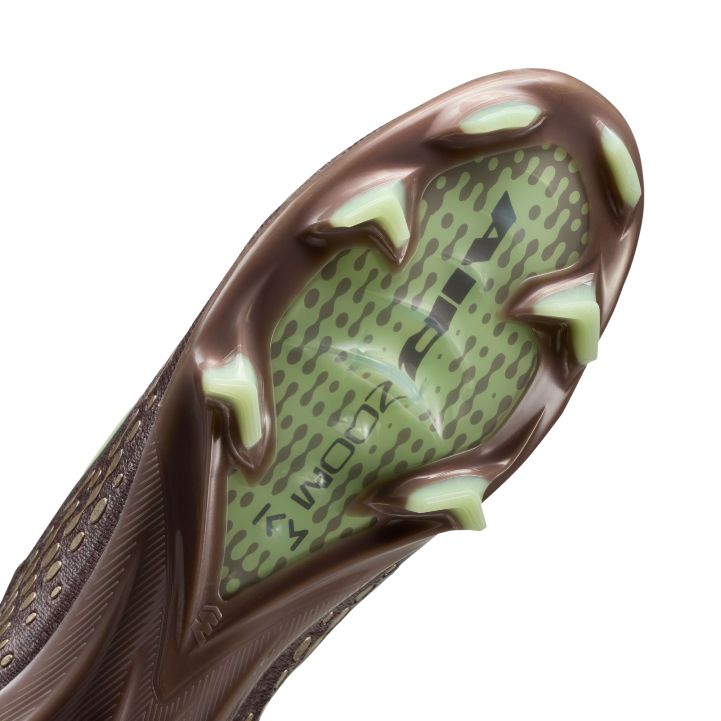 Close-up of the sole of a brown soccer cleat with pale green studs and a translucent green central panel featuring "AIR ZOOM" branding against a black background.