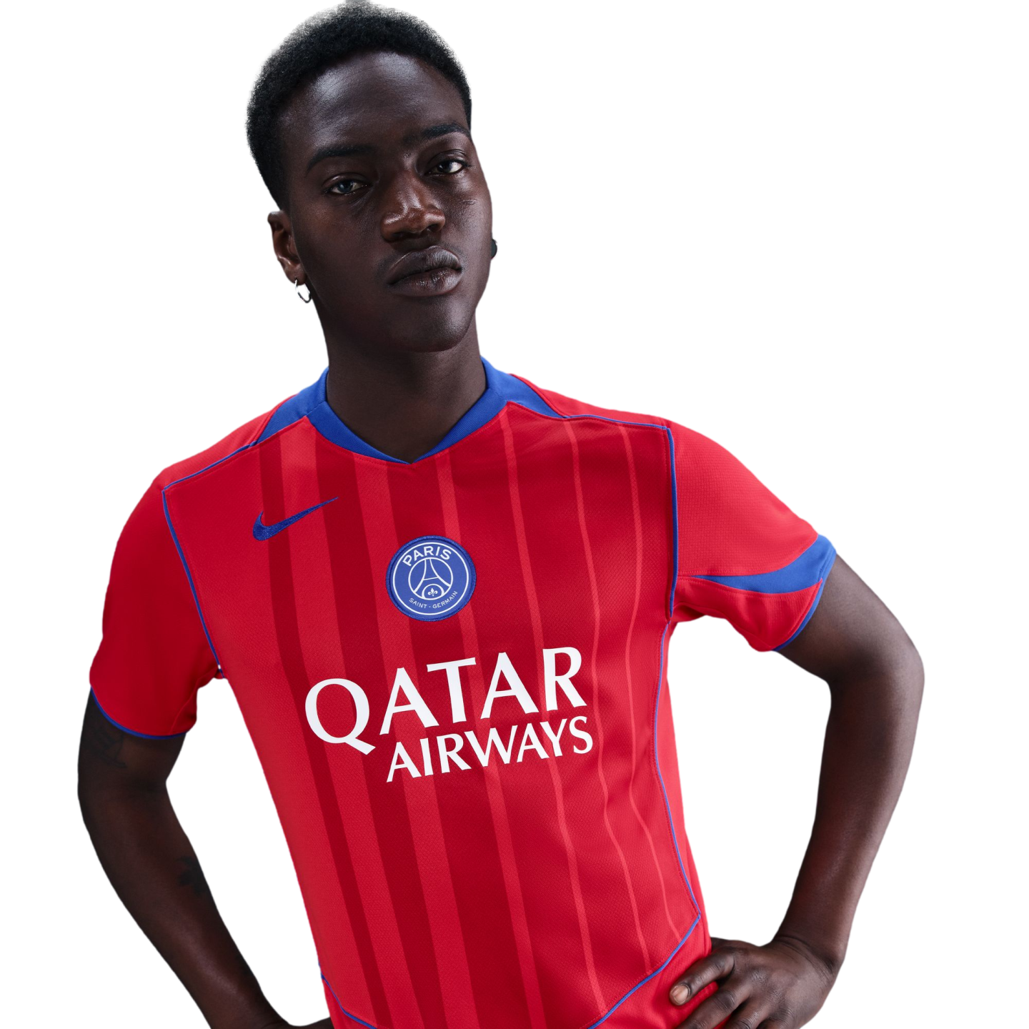 A young Black man posing in a red striped Paris Saint-Germain jersey with 'Qatar Airways' sponsor text and blue accents, set against a black background.