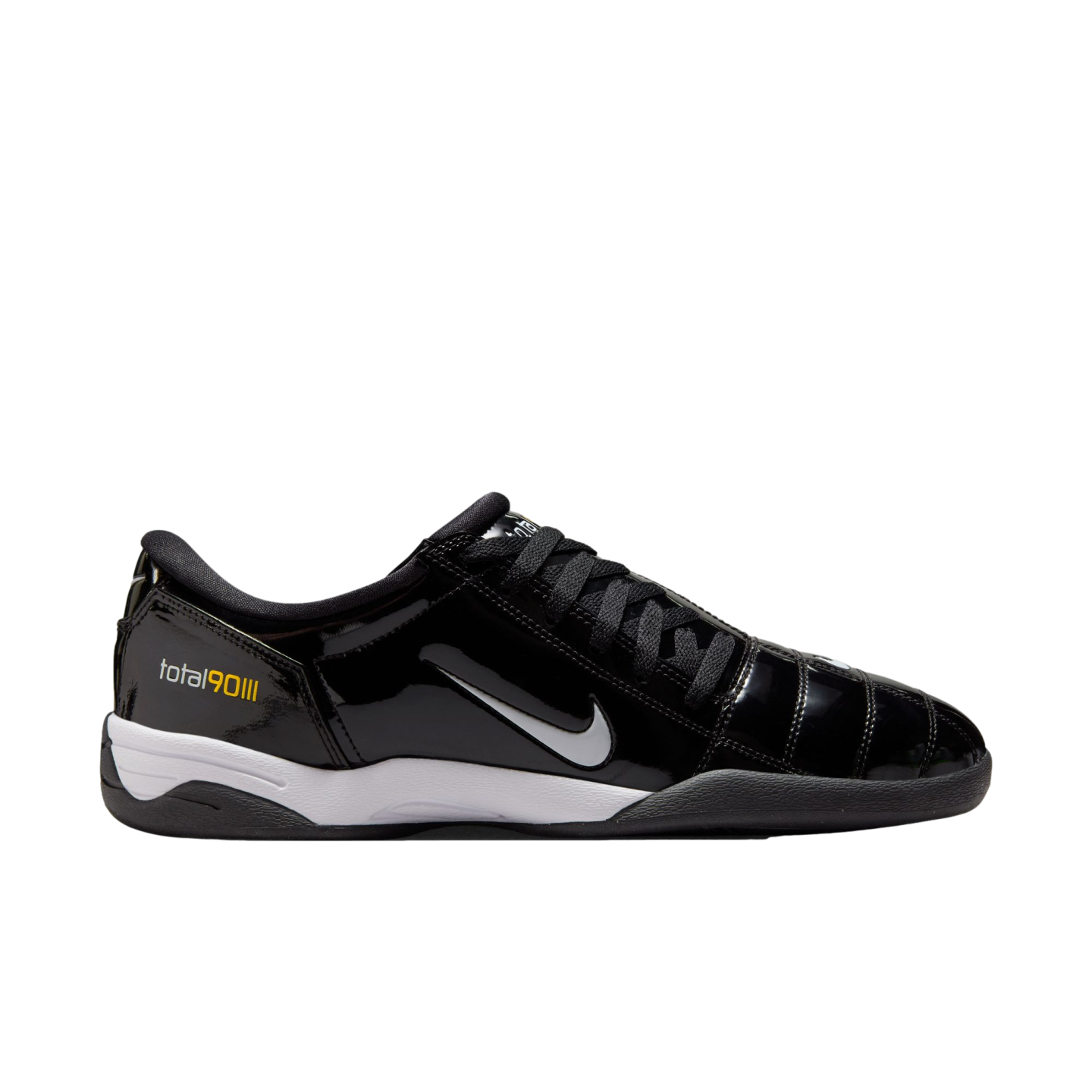 A side-profile view of a shiny black Nike Total 90 III indoor soccer shoe with a silver swoosh, white midsole, and black outsole.