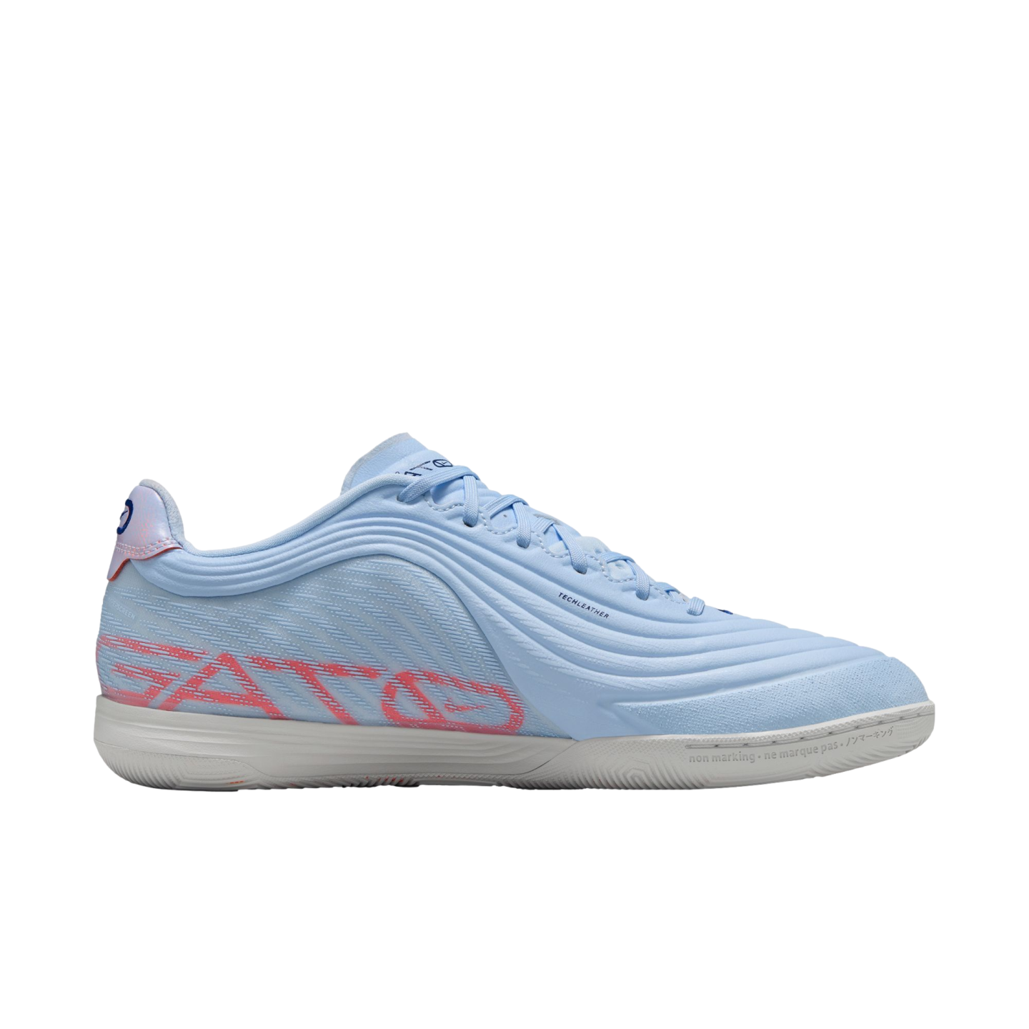 A side-view of a light-blue Nike Streetgato indoor soccer shoe with pink branding and a white sole, set against a solid black background.