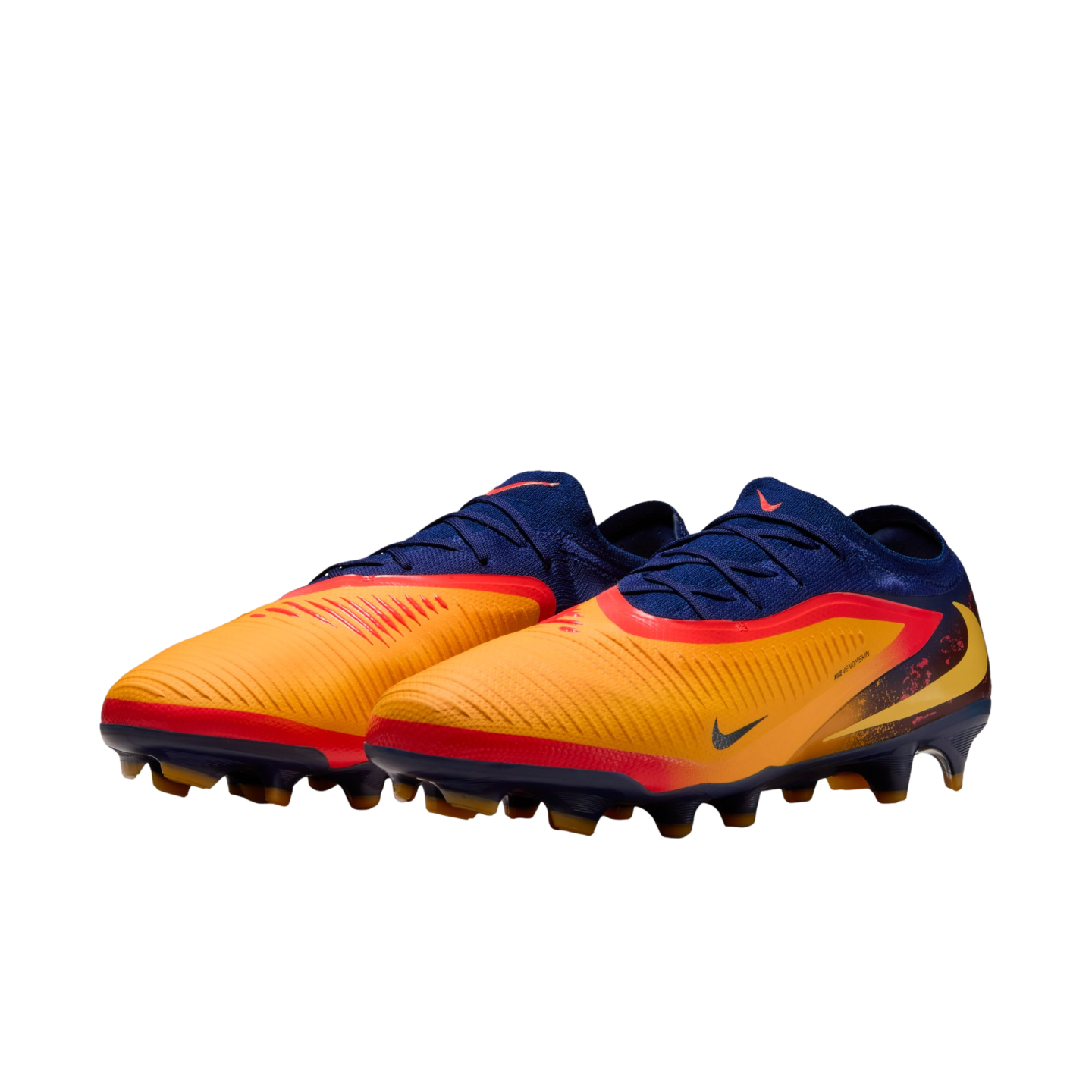 Nike soccer cleats with a navy blue and orange upper, red and yellow accents, and studded soles, shown against a black background.