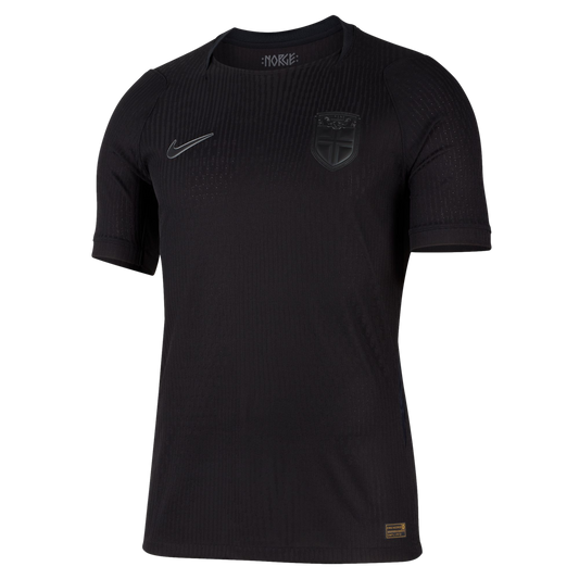 Black Nike short-sleeved soccer jersey with a subtle ribbed texture. Features a grey Nike swoosh, a monochrome shield crest, and "NORGE" text inside the collar.