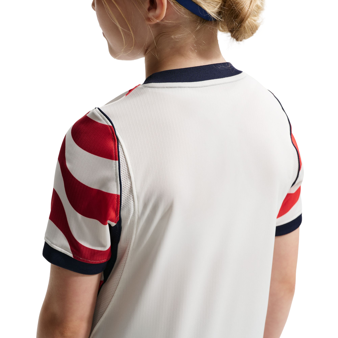 Rear view of a person wearing a white athletic jersey with red and white striped sleeves and navy blue trim.